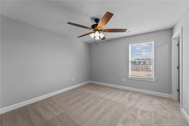 spare room with light carpet and ceiling fan