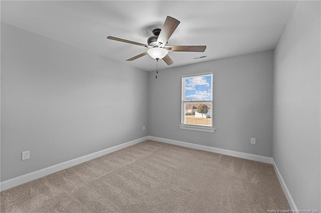 carpeted spare room with ceiling fan