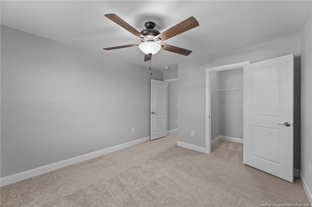 unfurnished bedroom featuring light carpet, a closet, and ceiling fan