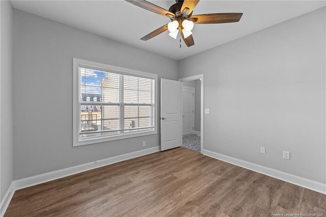 unfurnished room with wood-type flooring and ceiling fan