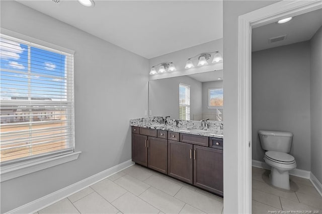 bathroom with vanity, tile patterned floors, and toilet