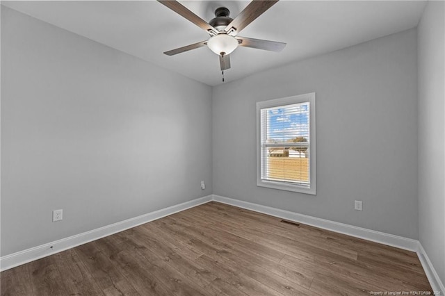 spare room with hardwood / wood-style floors and ceiling fan