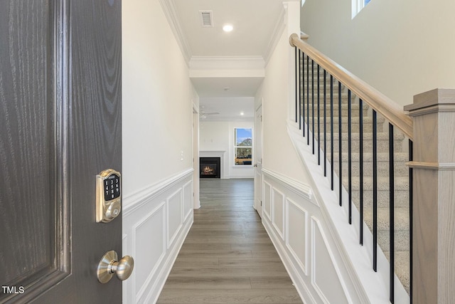 entrance foyer featuring wood-type flooring and ornamental molding