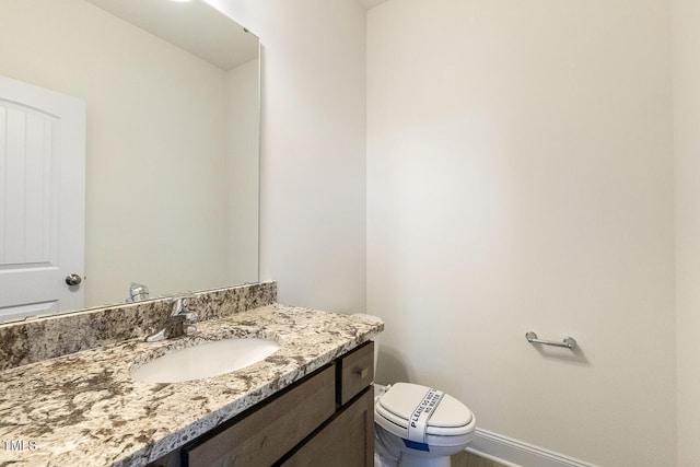 bathroom featuring toilet and vanity