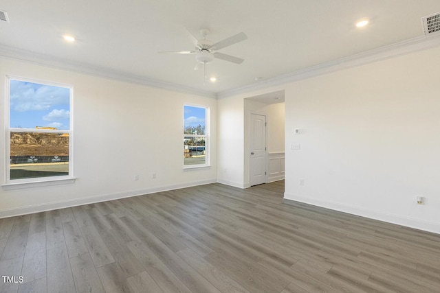 empty room with hardwood / wood-style floors, ceiling fan, and crown molding