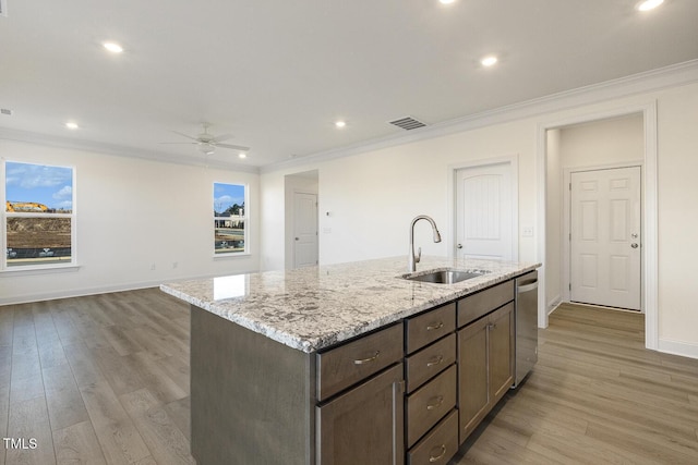 kitchen with sink, light hardwood / wood-style floors, dishwasher, and crown molding