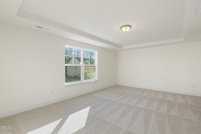 carpeted empty room featuring a raised ceiling