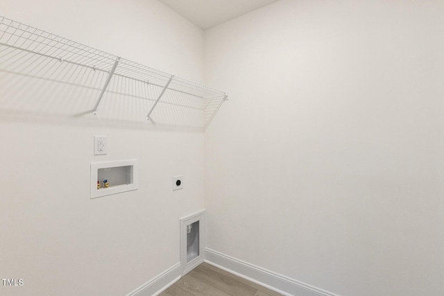 laundry area featuring hookup for a washing machine, light wood-type flooring, and electric dryer hookup