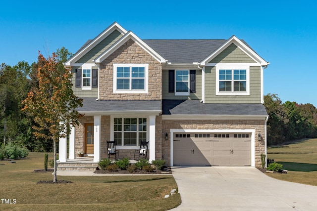 view of front of house with covered porch, a garage, concrete driveway, stone siding, and a front lawn