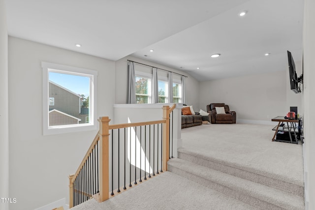 corridor with baseboards, carpet, vaulted ceiling, an upstairs landing, and recessed lighting