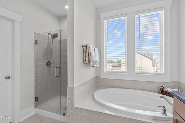 full bathroom featuring a stall shower and a garden tub