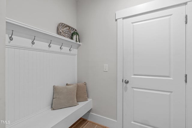 mudroom featuring wood finished floors and baseboards