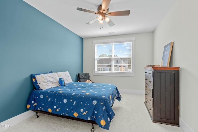 carpeted bedroom featuring ceiling fan, visible vents, and baseboards