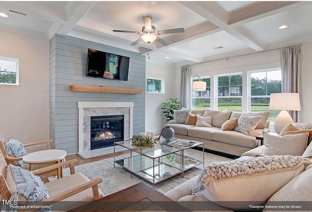 living room featuring a fireplace, beamed ceiling, coffered ceiling, and hardwood / wood-style flooring