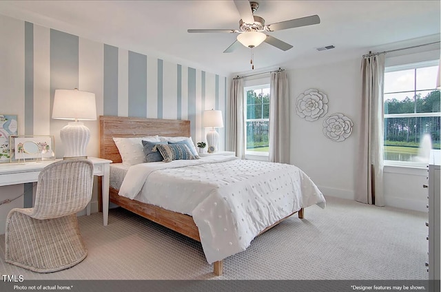 bedroom with ceiling fan and light carpet