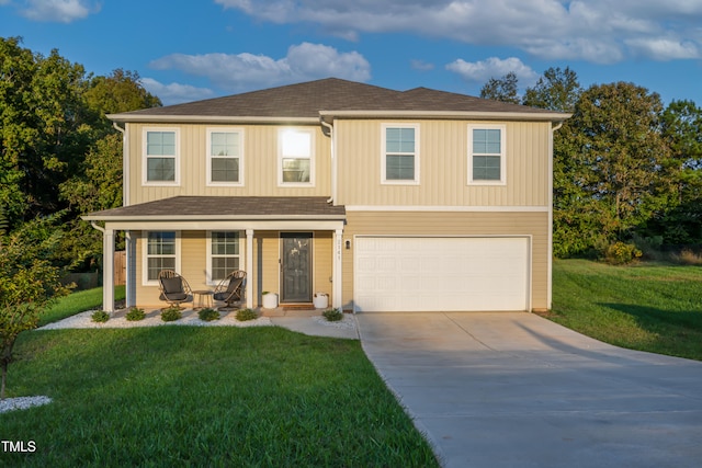 view of front of home with a front yard and a garage