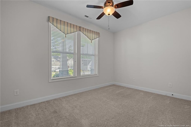 carpeted spare room with ceiling fan