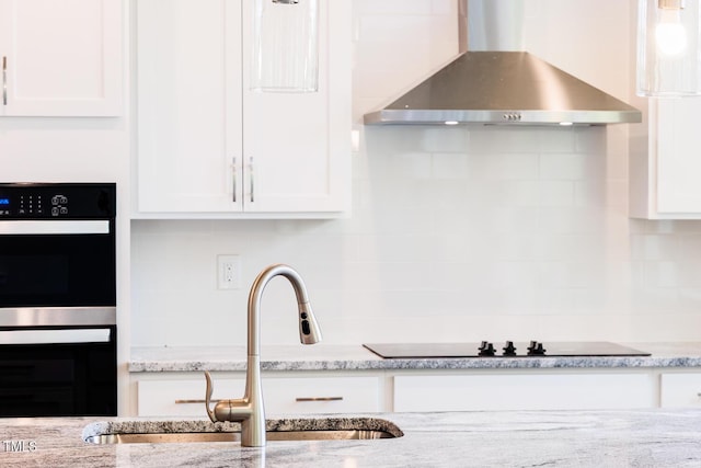 456 Barbour Farm Ln, Four Oaks, NC 27524 - kitchen featuring wall chimney range hood, a sink, black appliances, and white cabinetry