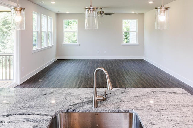 456 Barbour Farm Ln, Four Oaks, NC 27524 - kitchen with a sink, baseboards, wood finished floors, a ceiling fan, and light stone counters