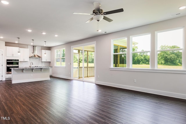 456 Barbour Farm Ln, Four Oaks, NC 27524 - unfurnished living room with baseboards, a sink, dark wood-style floors, ceiling fan, and recessed lighting