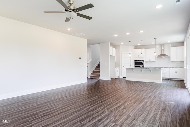 456 Barbour Farm Ln, Four Oaks, NC 27524 - unfurnished living room featuring baseboards, dark wood-type flooring, recessed lighting, stairs, and ceiling fan