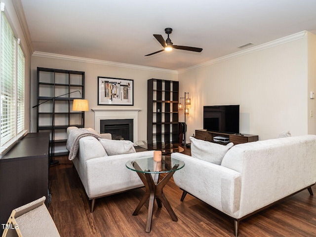 living room with ceiling fan, dark hardwood / wood-style floors, and crown molding