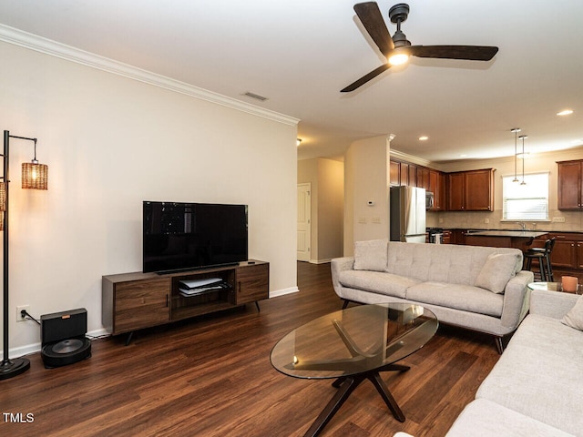 living room with crown molding, ceiling fan, and dark hardwood / wood-style flooring