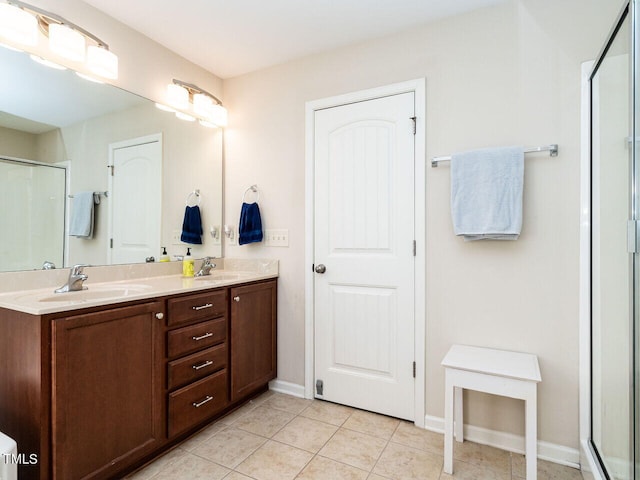 bathroom featuring walk in shower, vanity, and tile patterned floors