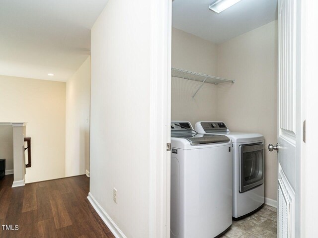 laundry area featuring washer and dryer and light wood-type flooring