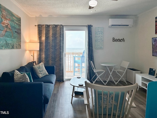 living room with dark wood-type flooring, a wall mounted AC, a textured ceiling, and ceiling fan