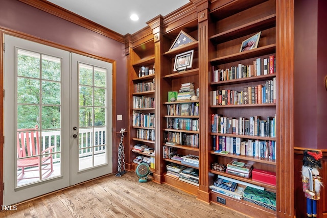 doorway featuring french doors, crown molding, and light wood-type flooring