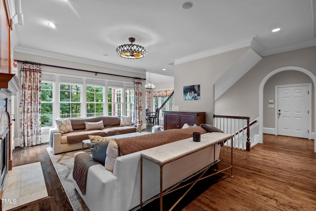 living room with crown molding, dark hardwood / wood-style flooring, and a chandelier