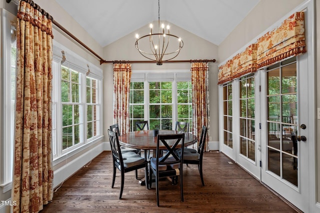 dining space with a notable chandelier, dark wood-type flooring, and vaulted ceiling