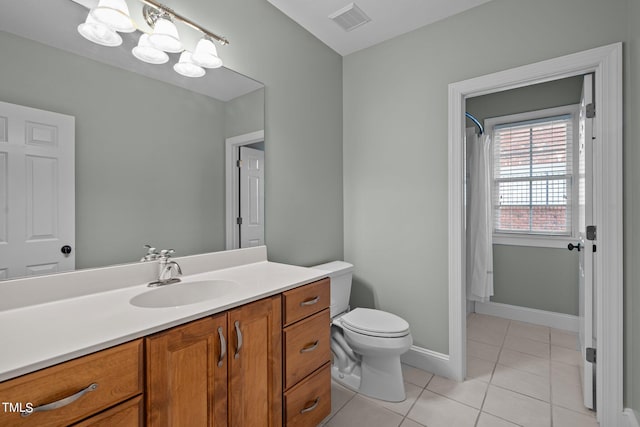 bathroom featuring vanity, toilet, and tile patterned flooring