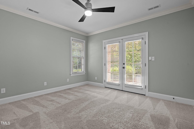 spare room with ornamental molding, french doors, light colored carpet, and ceiling fan