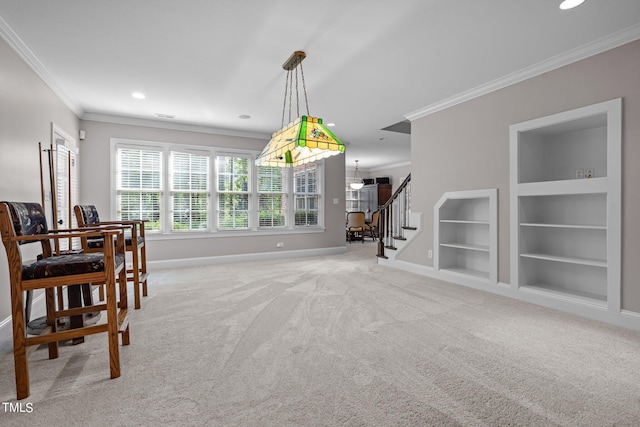 carpeted dining area with crown molding and built in features