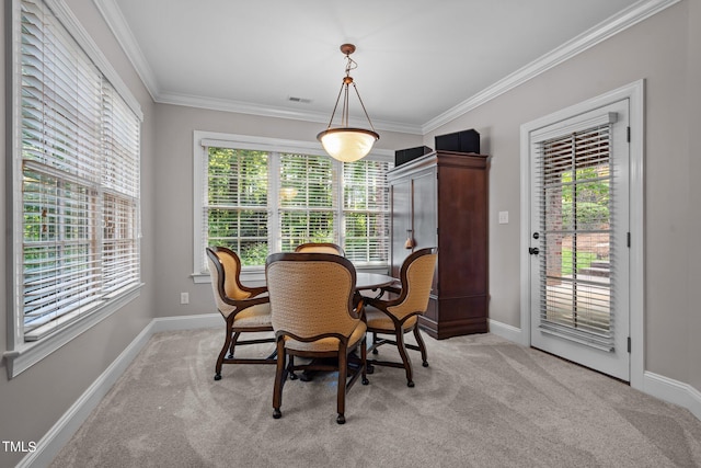 dining area featuring crown molding and light colored carpet