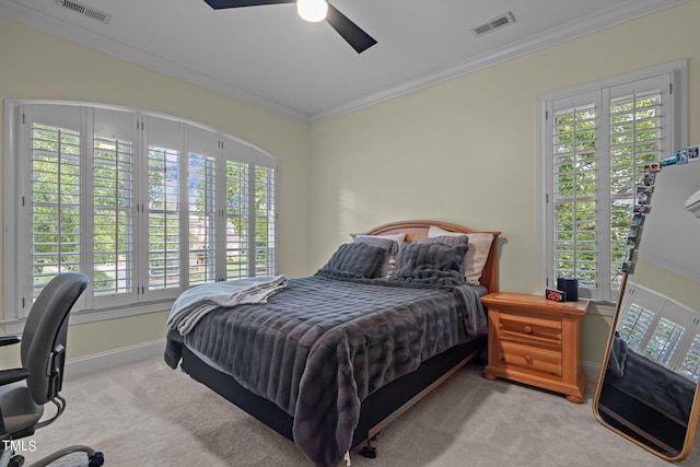 bedroom featuring ceiling fan, light carpet, and multiple windows