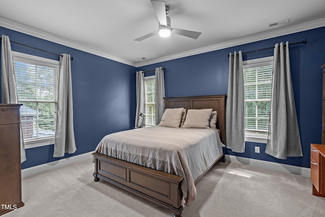 carpeted bedroom featuring ceiling fan, ornamental molding, and multiple windows