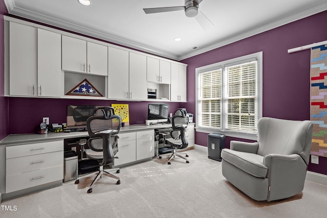 carpeted office space featuring ornamental molding and ceiling fan