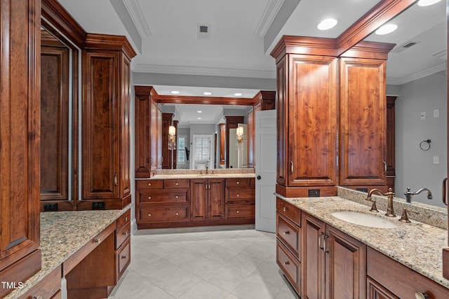 bathroom featuring vanity, ornamental molding, and decorative columns