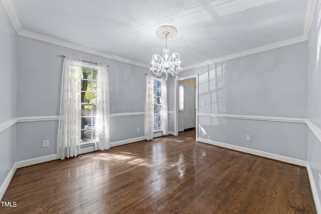 empty room featuring ornamental molding, a chandelier, and dark hardwood / wood-style flooring