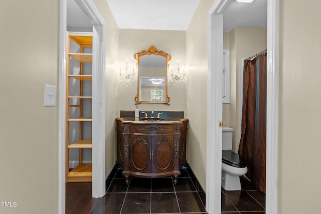 bathroom with vanity, tile patterned flooring, and toilet