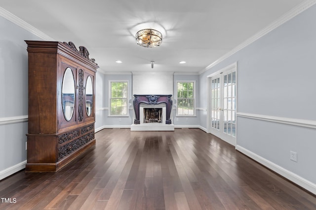 unfurnished living room featuring ornamental molding, a fireplace, and dark hardwood / wood-style flooring