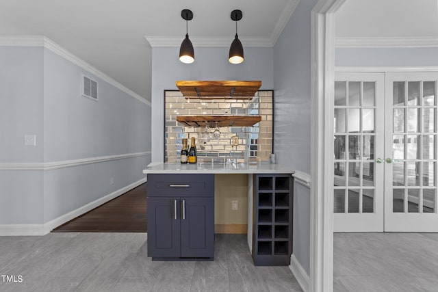 bar with french doors, hanging light fixtures, crown molding, and light wood-type flooring