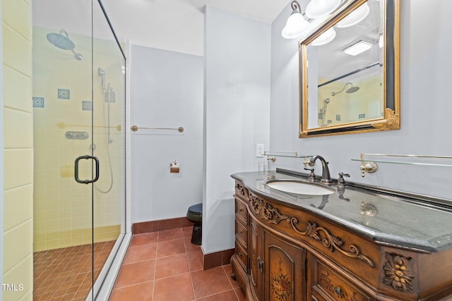 bathroom with walk in shower, tile patterned floors, vanity, and toilet