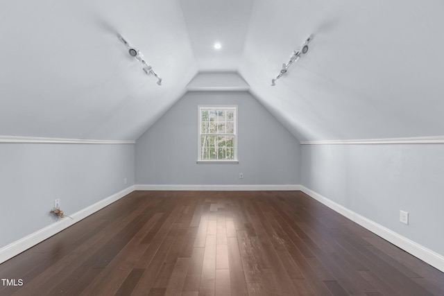 bonus room with dark wood-type flooring and vaulted ceiling