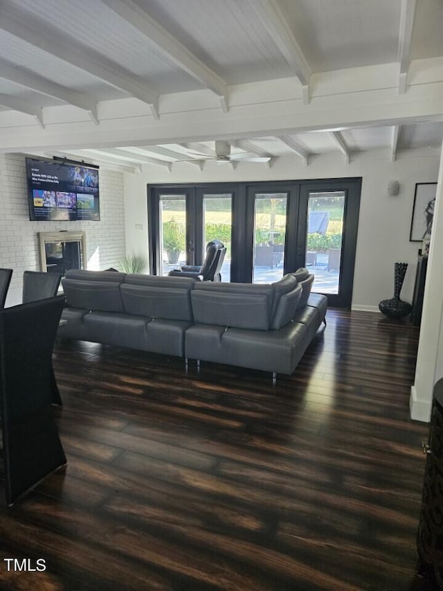 living room featuring baseboards, beam ceiling, dark wood-style floors, and french doors