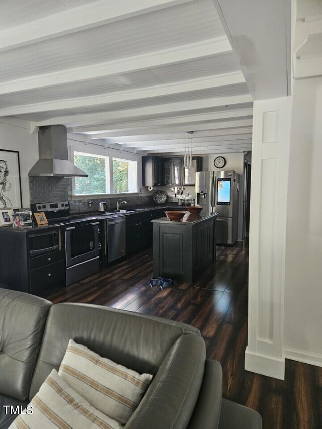 living room featuring dark wood-type flooring, beamed ceiling, and sink