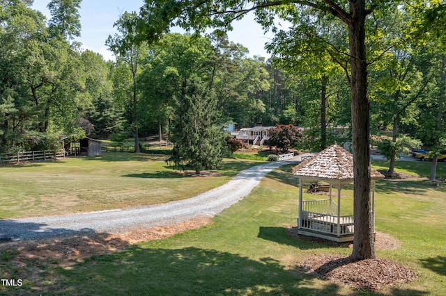 surrounding community with a yard and a gazebo